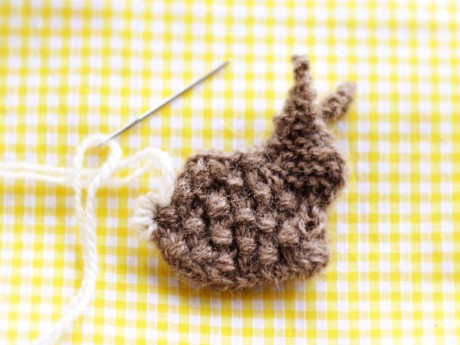 Wrap the yarn around the bunny tail loop to puff it up.