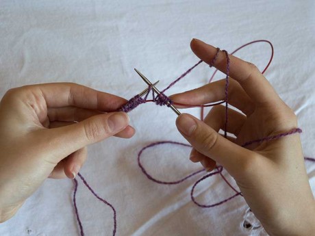 4. Begin knitting into the loops from one of the needles. Be careful not to twist the stitches as you knit. 