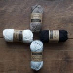 Scheepjes Catona Cotton. CW from top, 254 Moon Rock, 110 Jet Black, 172 Light Silver, 105 Cream. Loop, London www.loopknitlounge.com
