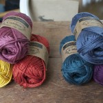 Scheepjes Catona Cotton. Left trio CW from top, 396 Rose Wine, 388 Rust, 249 Saffron. Right Trio CW from top 393 Charcoal, 394 Shadow Purple, 244 Spruce. Loop, London